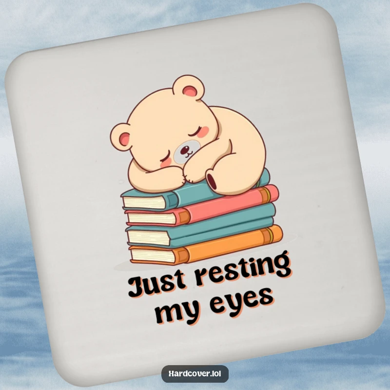 Funny sleepy bear design on a drink coaster, bear is asleep on a stack of books, protecting furniture.